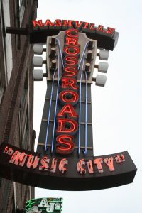 Large neon sign of guitar fretboard for Nashville, TN business named Crossroads